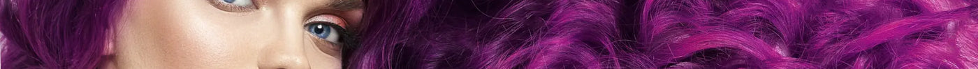 Vibrant purple curly gymnastics hairstyle ponytail over shoulder