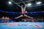 A women in a USA leotard performing gymnastics floor exercise