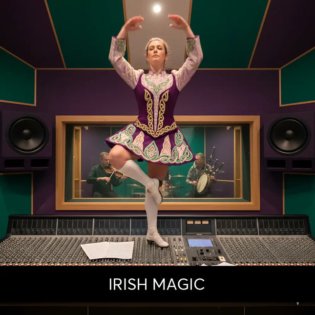 A woman in a vibrant purple and green celtic dance costume stands on an audio console for irish magic gymnastics floor music