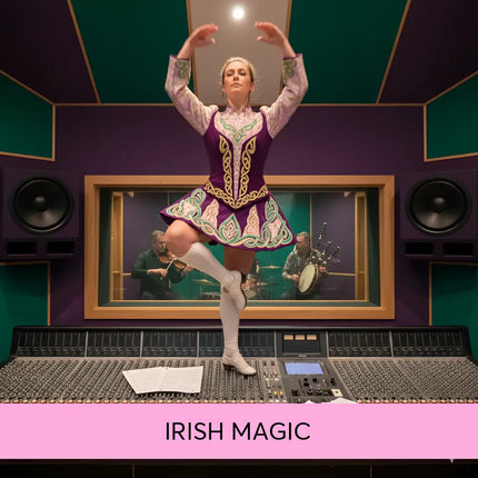 A woman in a vibrant purple and green celtic dance costume stands on an audio console for irish magic gymnastics floor music