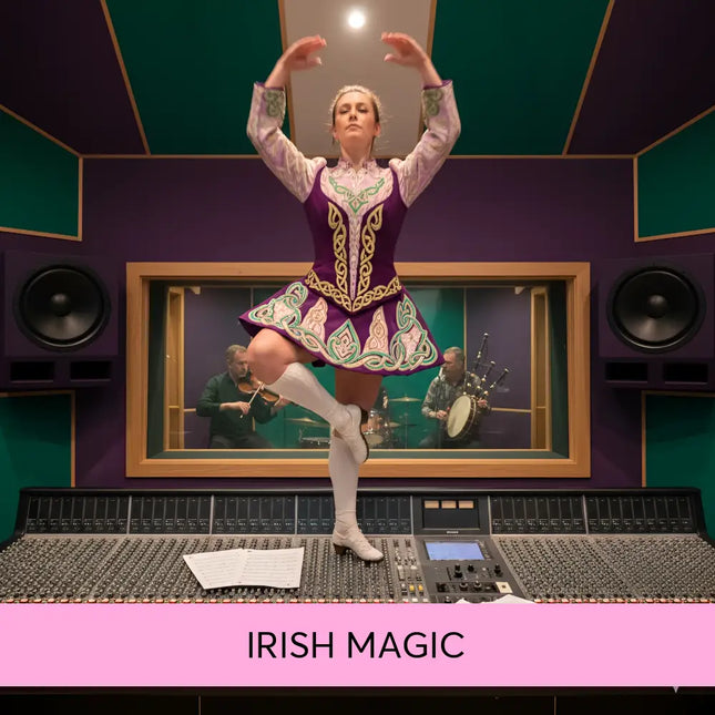 A woman in a vibrant purple and green celtic dance costume stands on an audio console for irish magic gymnastics floor music