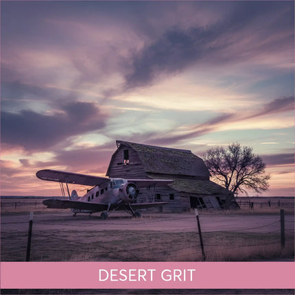 Vintage silver biplane by weathered barn in Desert Grit gymnastics floor music twilight