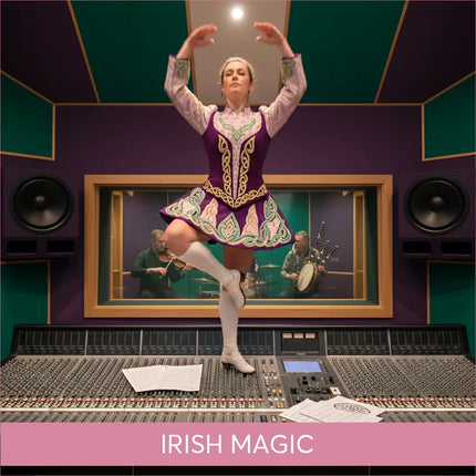 A woman in a vibrant purple and green celtic dance costume stands on an audio console for irish magic gymnastics floor music